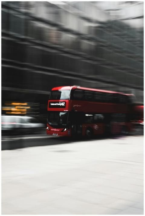 Blurred motion shot of a red double-decker bus spe