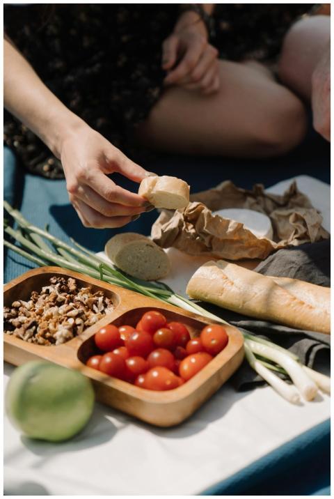 A relaxing outdoor picnic scene with fresh vegetab