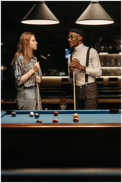 Young friends enjoying a game of pool at an indoor