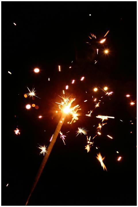 Bright sparkler illuminating the night with sparks