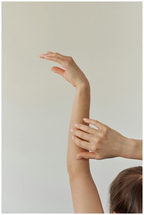 A serene composition featuring a woman's arm grace