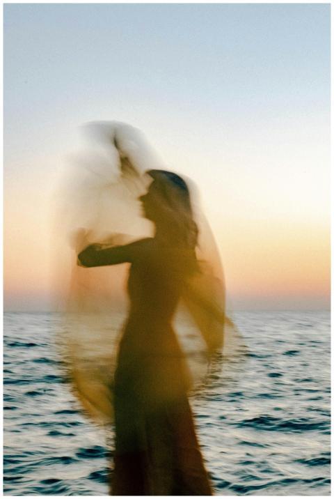 Blurred silhouette of a woman by the sea in Odessa