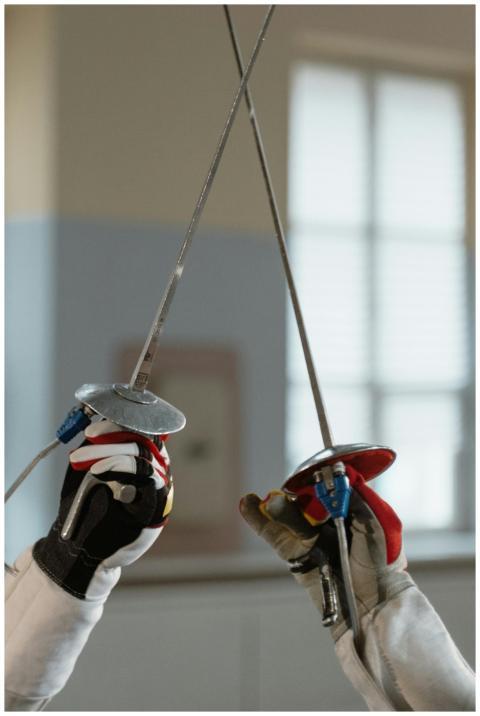Detailed close-up of two fencers clashing swords i