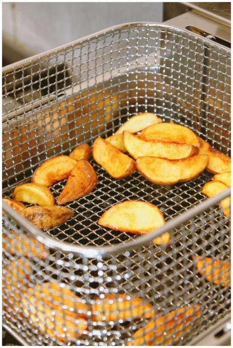 Golden brown potato wedges freshly fried and ready