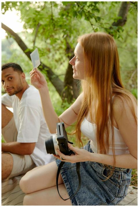 Two friends sitting outdoors, capturing moments wi