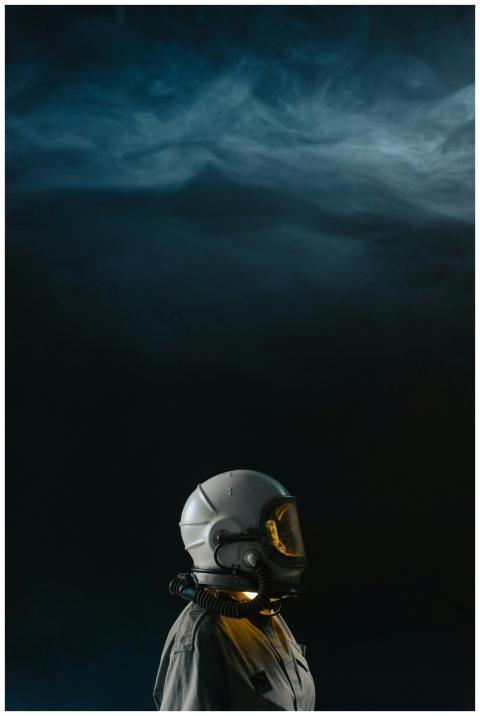 Exploring the unknown, a lone astronaut stands in