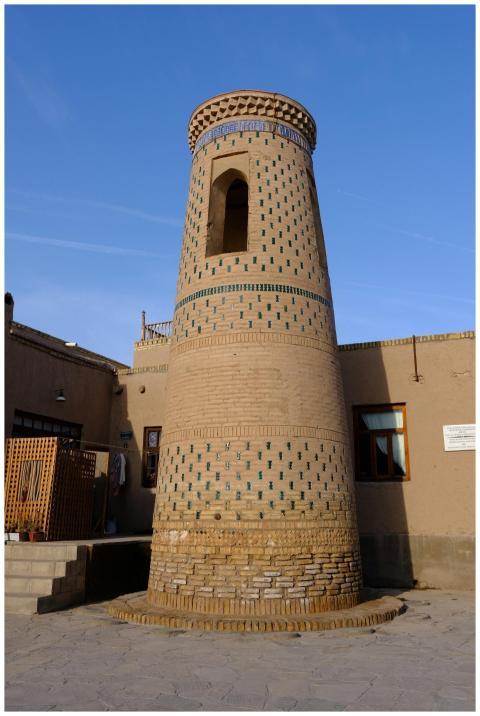 Explore the historic brick minaret in Khiva's anci