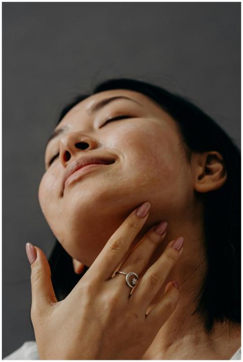Woman enjoying a facial massage with closed eyes a