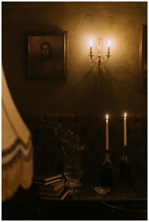A dimly lit vintage room with candles and retro de