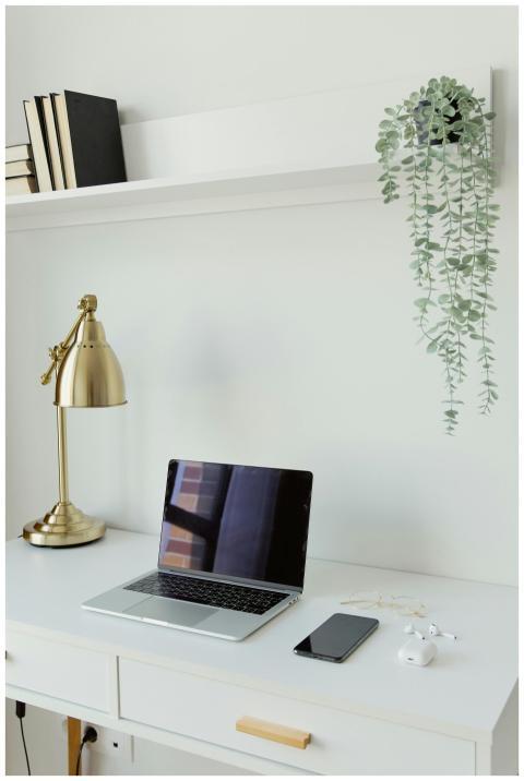 A modern, minimalist workspace featuring a laptop,