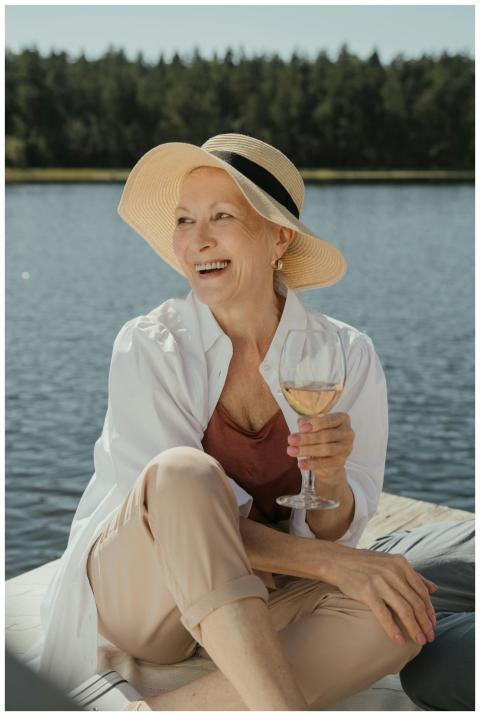 Senior woman enjoying a summer day on a pier with
