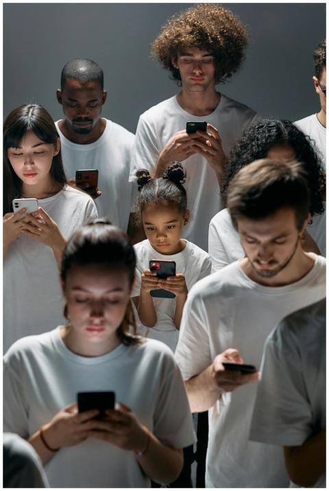 A diverse group of people focused on their smartph