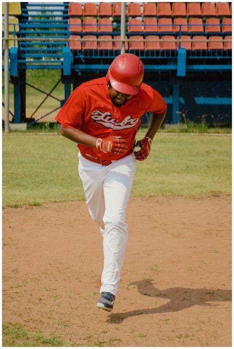 Energetic athlete in red and white uniform playing