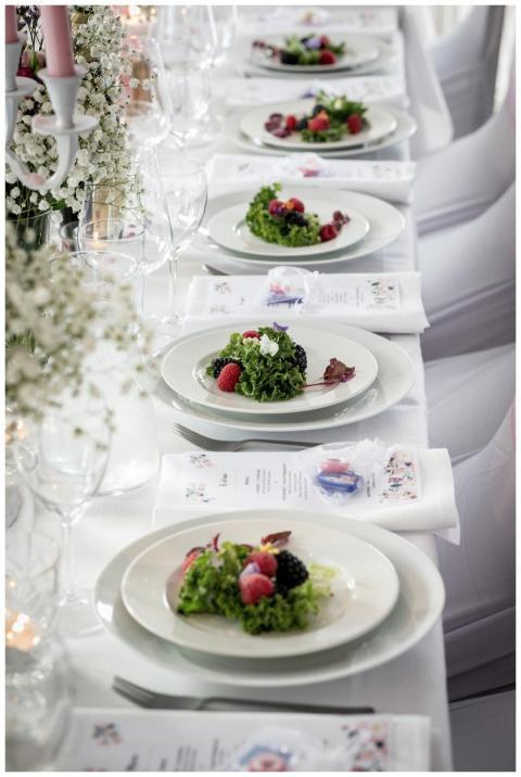 Beautifully arranged wedding table setting with fr