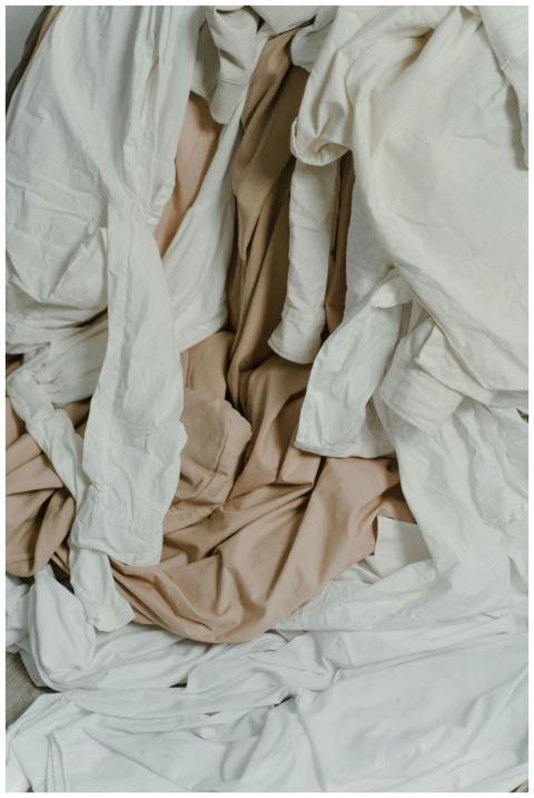 A heap of beige and white fabrics showcasing textu