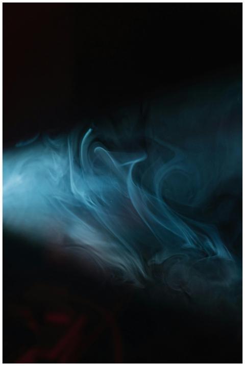 Moody abstract image of swirling blue smoke with d