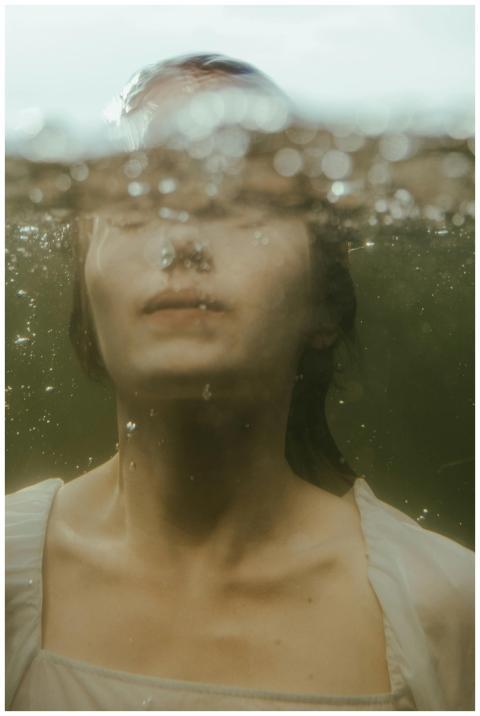 Mystical underwater shot of a woman with bubbles,