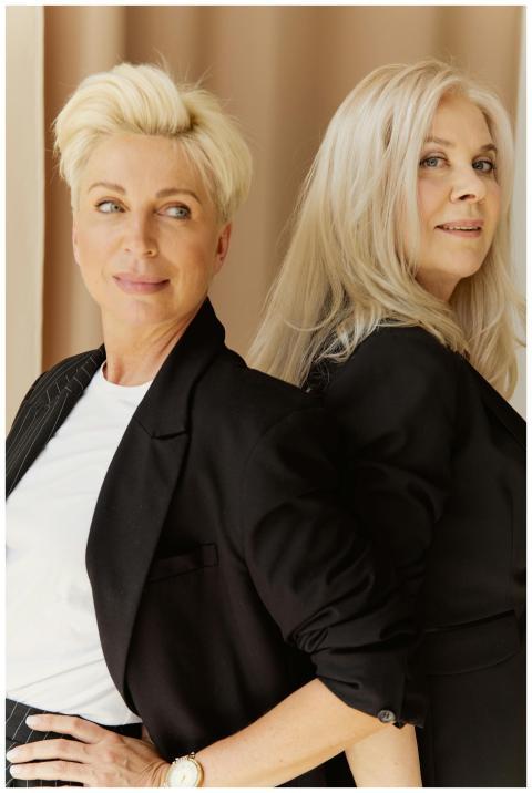 Chic portrait of two mature businesswomen wearing