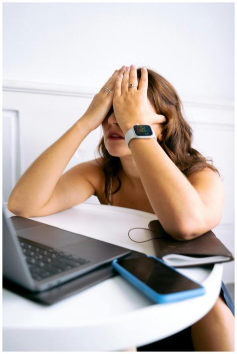 Woman showing stress or tiredness with hands on fa