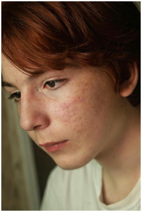 Close-up portrait of a thoughtful young person wit
