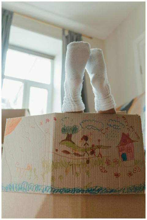 Child's feet in socks peeking out of a decorated c