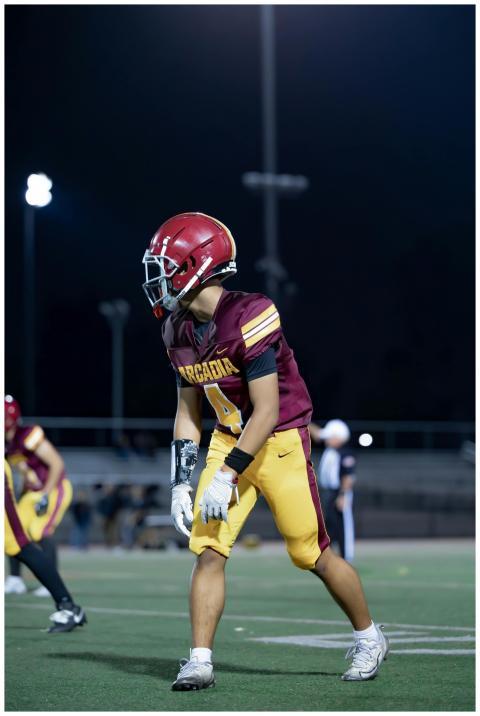 Focused high school football player in uniform on