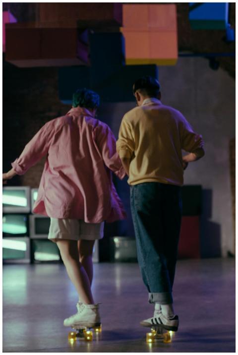 Two trendy teenagers enjoy indoor skating under co