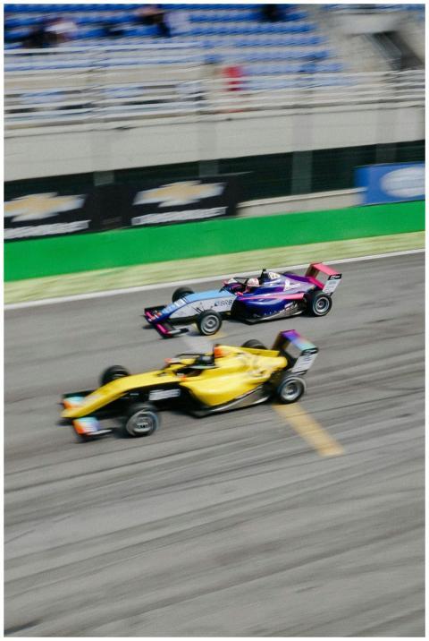 Two race cars in a thrilling high-speed competitio
