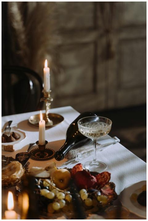 A sophisticated dining table with candles, wine, a