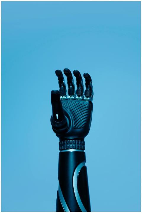 A high-tech robotic prosthetic arm reaching upward