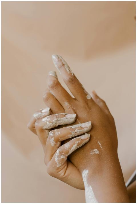 Close-up of hands engaged in artistic clay working