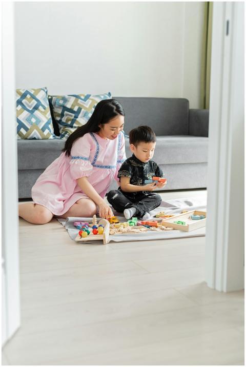 Asian mother and son playing and bonding with colo