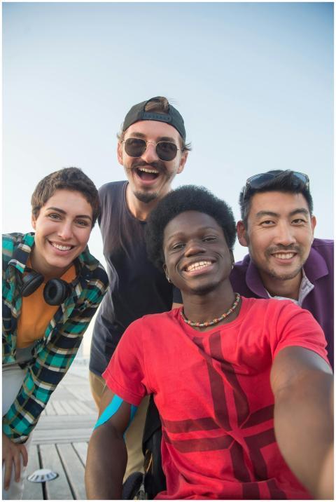 Diverse group of friends smiling and posing togeth
