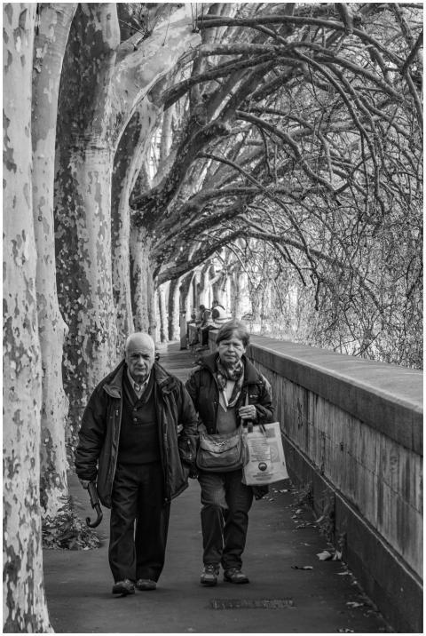 Black and white photo of an elderly couple walking