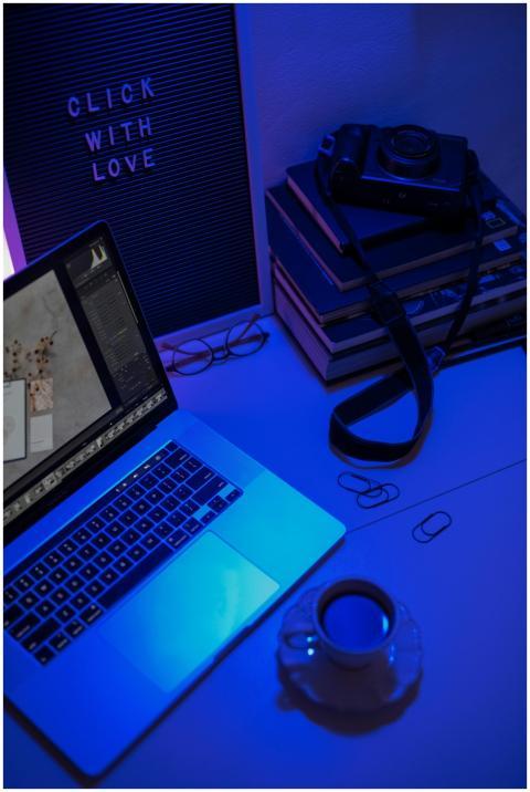 A stylish workspace featuring a laptop, camera, an
