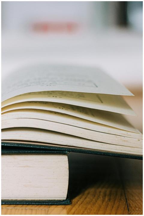 Artistic close-up of an open book with visible pag