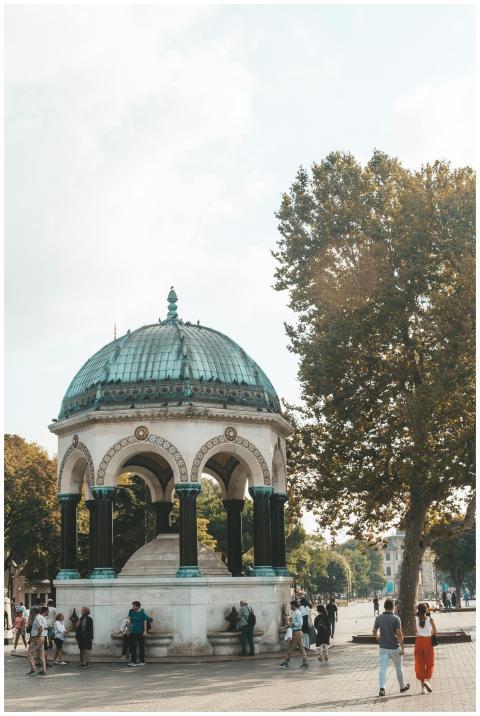 Historic pavilion with a domed roof in a lively ci