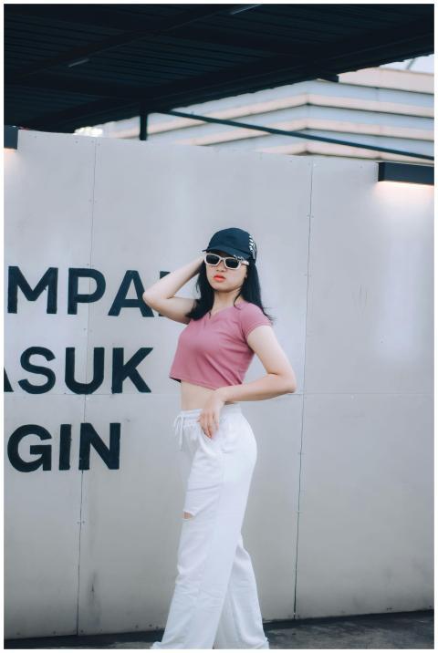 Fashionable woman wearing a crop top and sunglasse