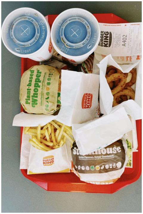 Tray of fast food with burgers, fries, and drinks