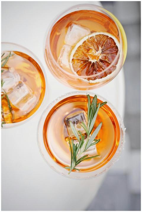 Top view of three citrus and rosemary cocktails wi