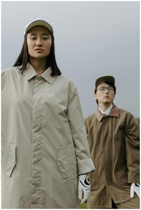 Two stylish golfers posing outdoors in autumn atti