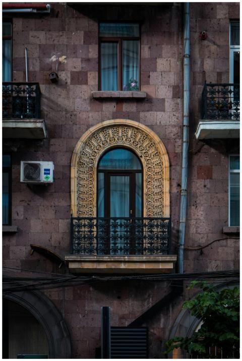 Intricately designed balcony on a classic stone fa
