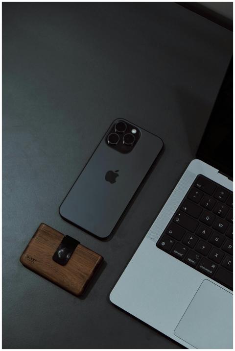 Top view of a sleek smartphone and laptop on a des