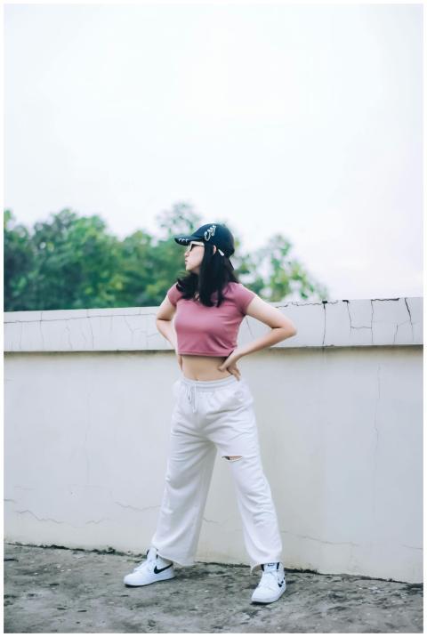 Stylish woman posing confidently in urban rooftop