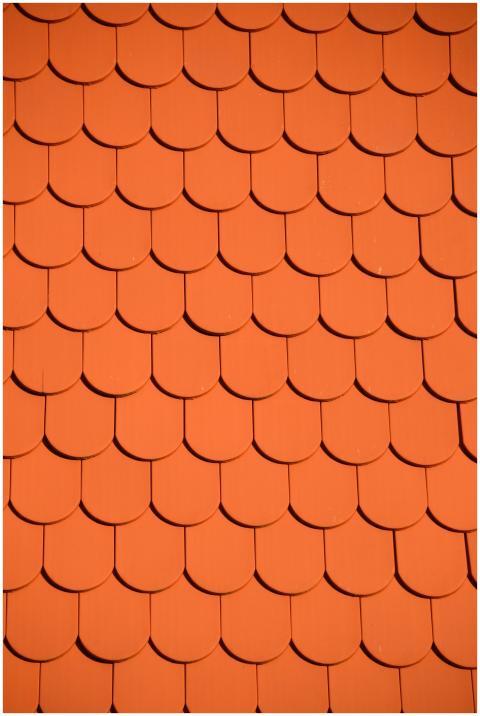 Bright orange roof tiles arranged in a seamless re