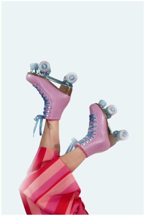 Vibrant pink roller skates with legs in red stripe