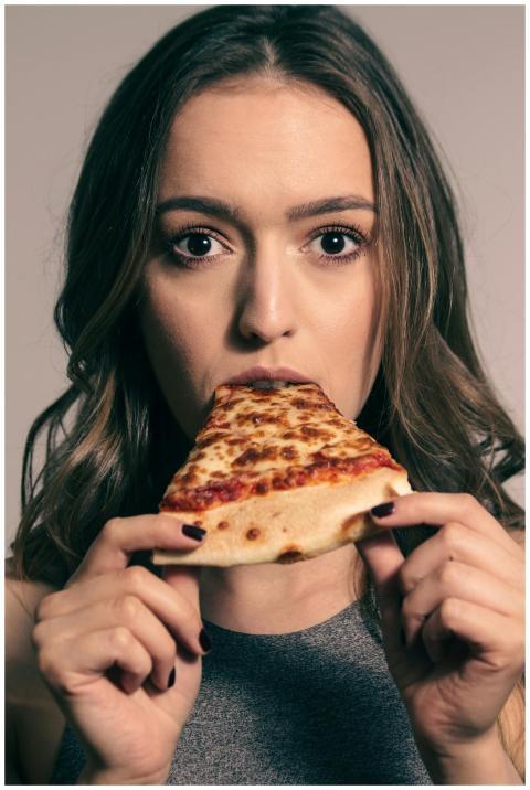 Astonished young female with long dark biting slic