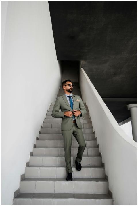 A fashionable man in a suit walking up stairs in D