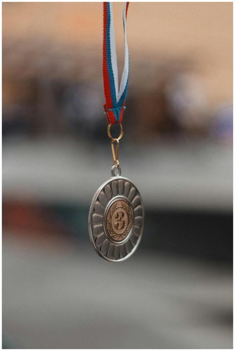Detailed photo of a silver medal with tricolor rib