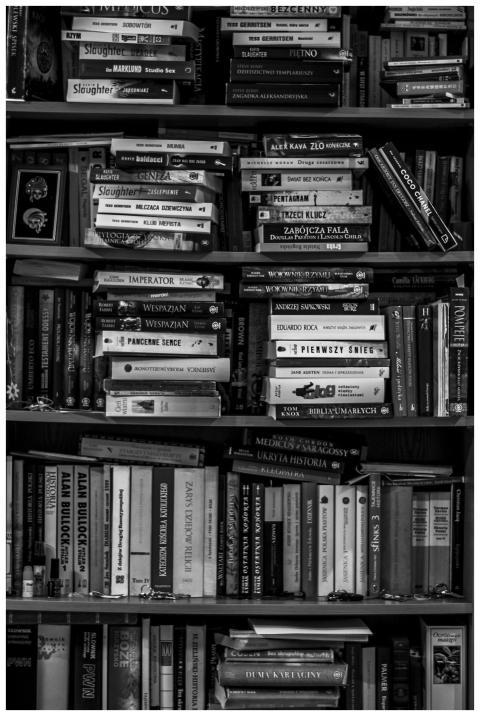 A black and white image of a packed bookshelf with